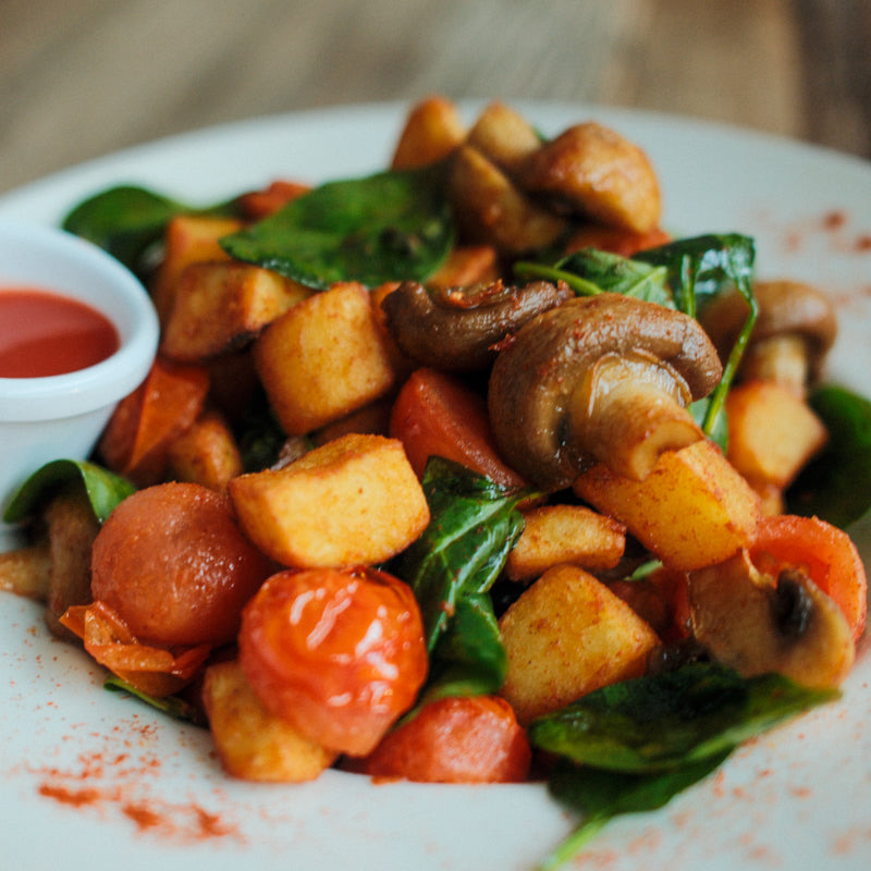 Roasted potatoes, mushrooms and tomatoes with spinach