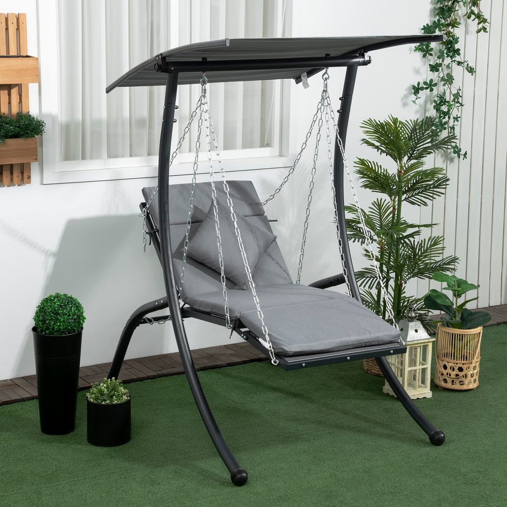 A garden swing seat with a canopy beside potted plants