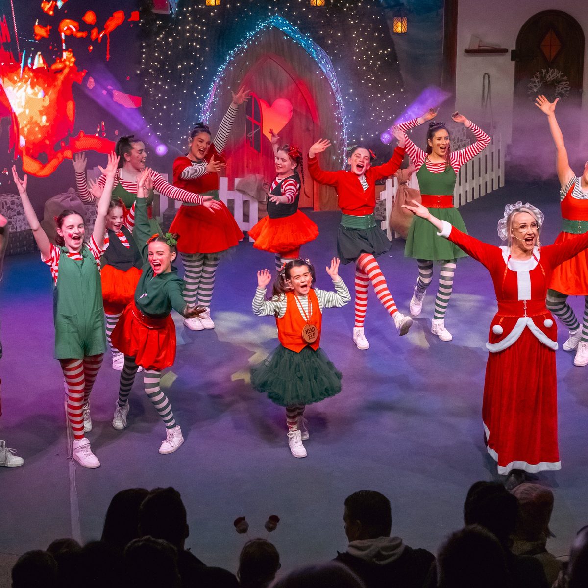 Elves and Mrs Claus dancing on stage in the Santa Train Big Top show